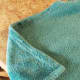 Lay your blanket flat. Starting on one side, begin folding the corner in.