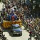 A truck-pulled float moves down a crowded street as part of a modern-day Fat Tuesday celebration in Mobile, Alabama. 
