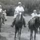 &quot;Couldn't get Carol to go on the horses.  Peggy, Ralph, Johnny&quot; (Riding horses at Last Frontier Game Lodge, 1950s)