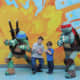 Kids getting their picture take with the Teenage Mutant Ninja Turtles