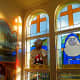 Stained glass windows (circa 1984) of Father Damien and Mother Marianne were designed and created by artist Ken Burkhardt.