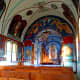 Colorful murals and paintings cover much of the church interior.