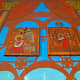Wood carving depicts biblical scenes.