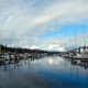 The lines of privately owned boats--in this case, C-Dories on the left, large yachts on the right--are highlighted by the flat, barely rippled water reflecting the vivid sky over Friday Harbor Marina.