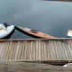 Several types of dinghies were parked at a dock in the marina. They were used to paddle out to anchored boats.One was an attractive, handmade wooden kayak.