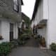 Narrow Lane in Hawkshead Village with pots and hanging baskets in bloom