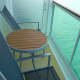 Balcony has 2 rather large chairs, and a tall, round table.