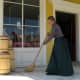 Sweeping the porch of the general store.