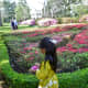 Girl walking by the butterfly shaped garden