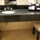 The rich black bathroom counter top.