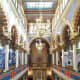 Well-lit interior of Jerusalem Synagogue.