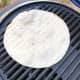 Warming up the tortilla wrap on the grill.