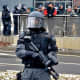 Policeman carries a pepper spray rifle