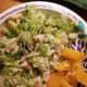 Parmesan salad with orange slices on the side
