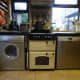 Our washing machine with built-in dryer, in the kitchen next to the cooker; and on the other side of the cooker is the dishwasher.