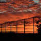 The sunset over a barbed-wire fence