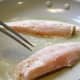 Larger half of the fish fillets are in the pan for a few minutes before the thinner parts are added.