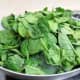 Add the fresh spinach leaves to the pan with the onions.