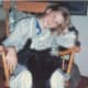 This shows Sarah relaxing at home with Moses in her lap.