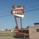 A sign once bright, beckoned in the California desert