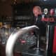 The waitress and bartender working hard at the bar.
