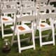 White wooden or resin folding chairs like these typically rent for around $2&ndash;$5 each. 