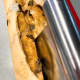To make a braided loaf, cut the log in half crosswise using a sharp knife or dough scraper,