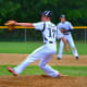 Step 4: As the leg kicks forward, notice how the arms are spread like wings. This extension is important; throwing the glove out toward the plate and reaching back toward 2nd base with the ball.