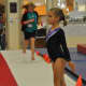 Gymnast at attention - awaiting start of Level 5 floor routine