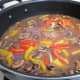 Add the Marsala wine and chicken broth to all of the vegetables