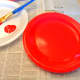 Paint a paper plate red.