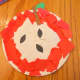 Glue on pieces of construction paper to paper plate to create apple design.