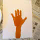 Paint the child's hand and arm brown and press on paper to make tree trunk.