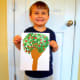 My son proudly displaying his apple tree.