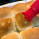 Brush the buns with melted butter. 