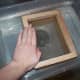 Step 4: Hold the deckle in the water with one hand.