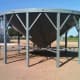 The finished hopper sits out of the way near to the site where its grain bin will be built.