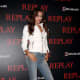 Irina Shayk posing on the event carpet in faded skinnies and towering heels