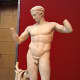 Full-length photo of the Diadoumenos, Polykleitos' well-known statue of an athlete crowning himself. The weight shift onto one hip that Polykleitos first captured became a staple of Greek art. c. 420 BCE.
