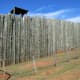 This shows what the stockade wall looked like with a guard tower. The reconstructed dead line is the short fence in the foreground. 