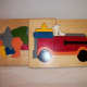 Small wood connecting puzzles.  Rhino and baby, and fire engine with fire dog.