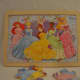 12-piece Disney Princesses interlocking puzzle, with identical background.