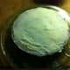 Spread cream cheese frosting on first cake. You may want to add a sprinkling of coconut to the center as well.