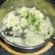 Chopped chives are added to the mashed potato
