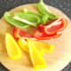 Bell pepper halves are roughly chopped for stock