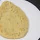 Naan bread is served with chicken leg bhuna
