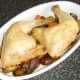 Chicken legs are laid on the vegetables, ready to be garnished and served