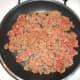Brown meat in a frying pan