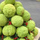 Continue to glue decorations in gaps around entire tree.