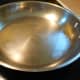 Fill a 10-12 inch stainless steel skillet with 1/4 - 1/2 cup water.  